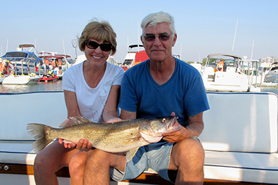 Two anglers are all smiles as they show off a large walleye caught in western Lake Erie.